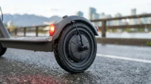 Close-up of a digital LED dashboard on a single motor electric scooter displaying speed and battery life.