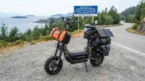Electric scooter for long distance travel outfitted with a front handlebar bag and safety helmet for touring.