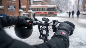 A rider in Canada wearing insulated gloves and a helmet while operating a 1500W electric scooter.