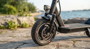 Close-up of anti-slip tires and bright LED safety lights on an affordable commuter electric scooter designed for changing Canadian weather.