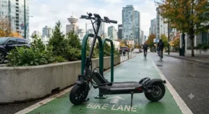 Close-up of an electric scooter for medium commutes parked securely in a designated Vancouver protected bike lane.