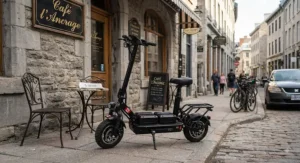 A durable dual battery scooter for extended range parked outside a cafe in historic Montreal