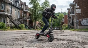 High speed electric scooter for experienced riders tackling rough asphalt with advanced front and rear suspension in Montreal.