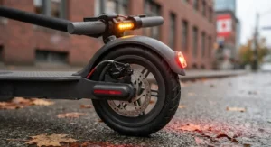 Close-up of bright LED safety lights and braking system on a budget-friendly electric scooter.
